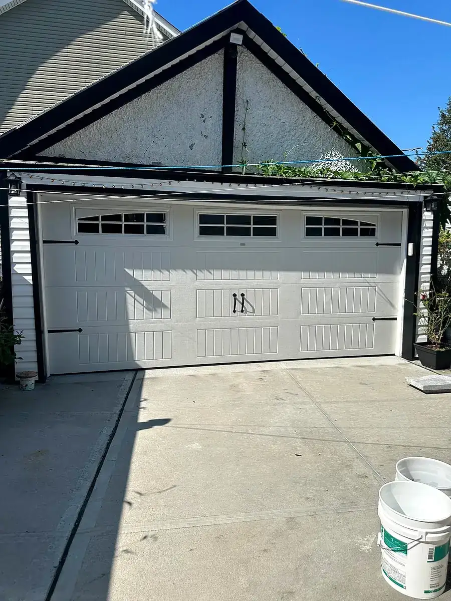 White carriage door with windows on a detached garage