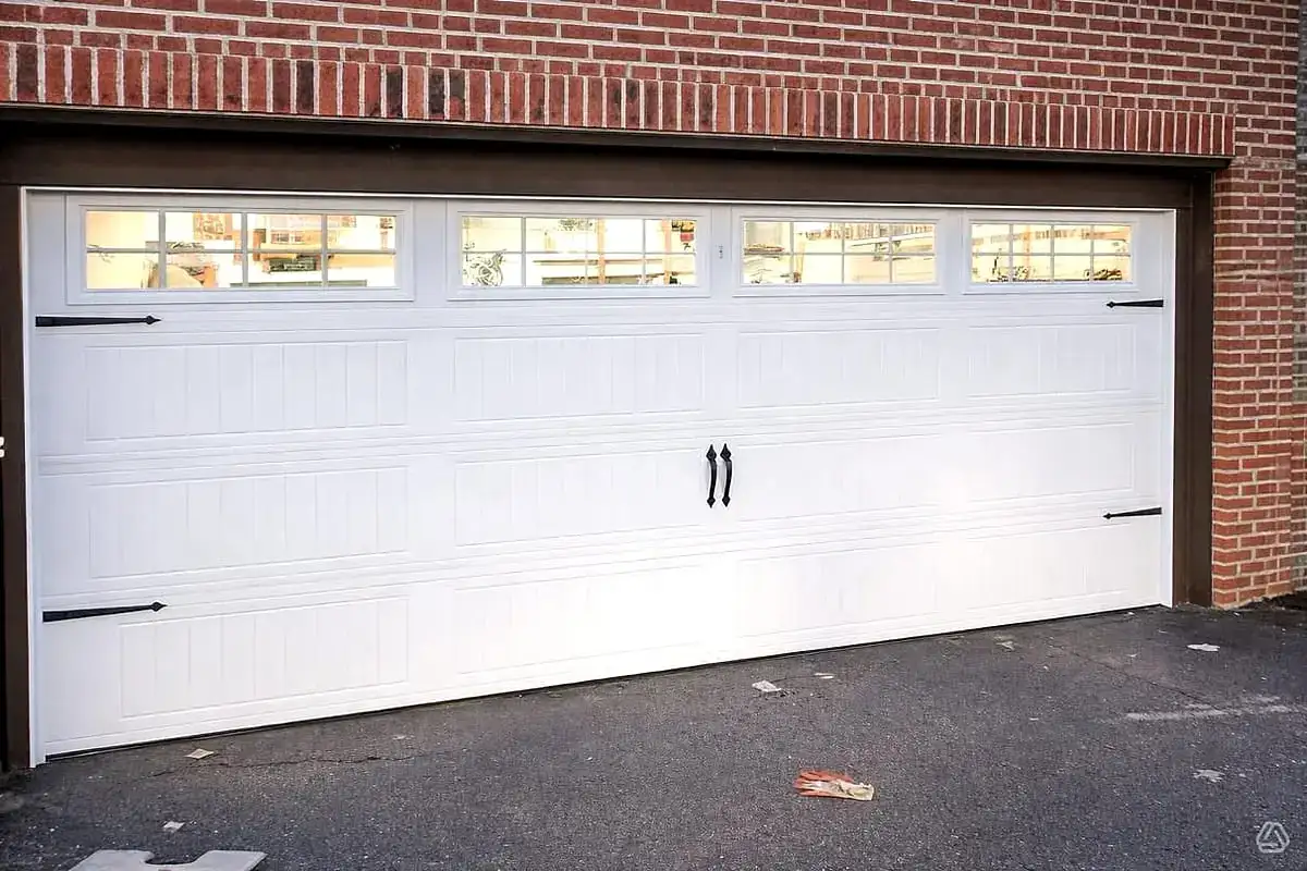 White long-panel carriage door with windows and decorative hardware