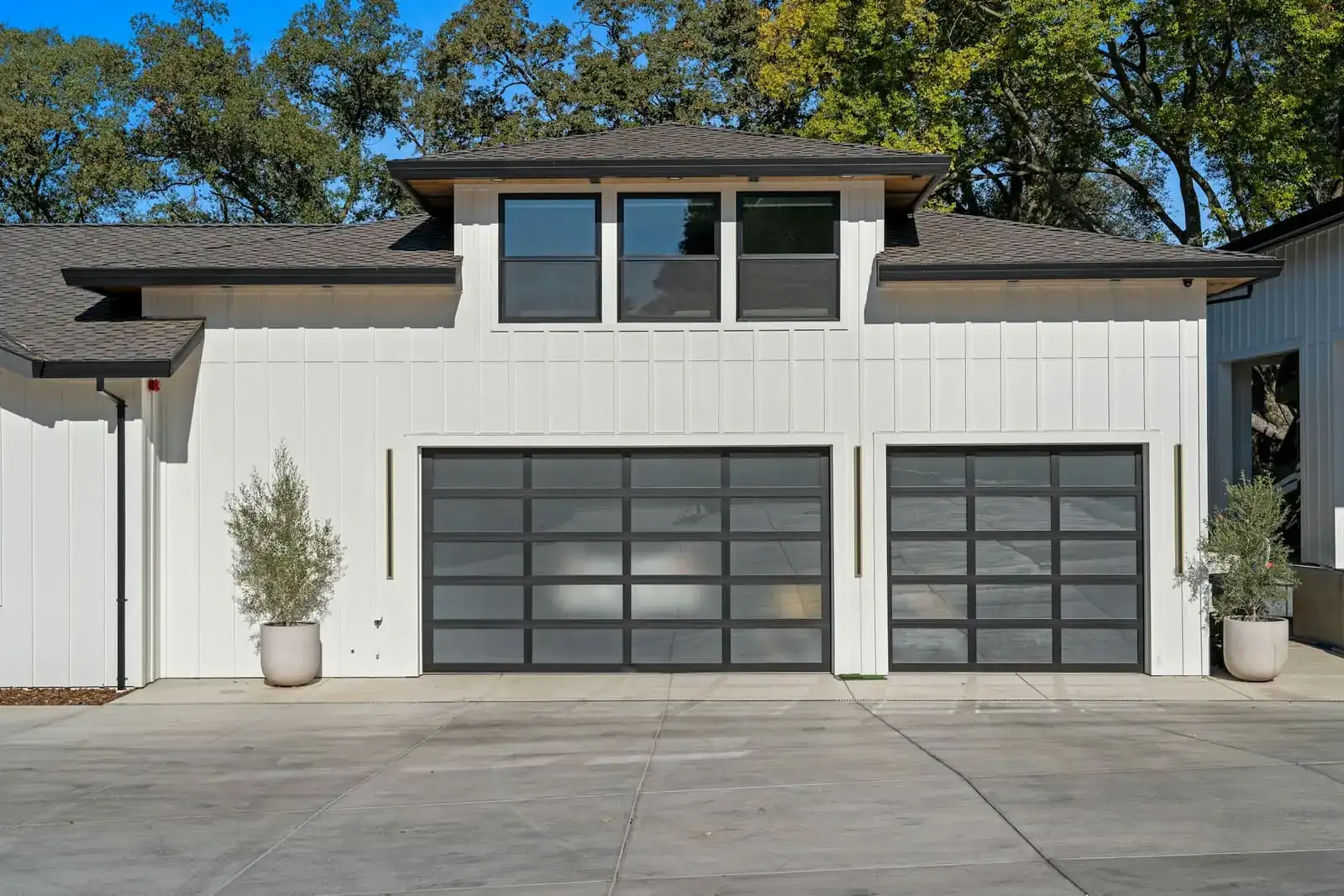 Twin flush-panel doors on a white colonial