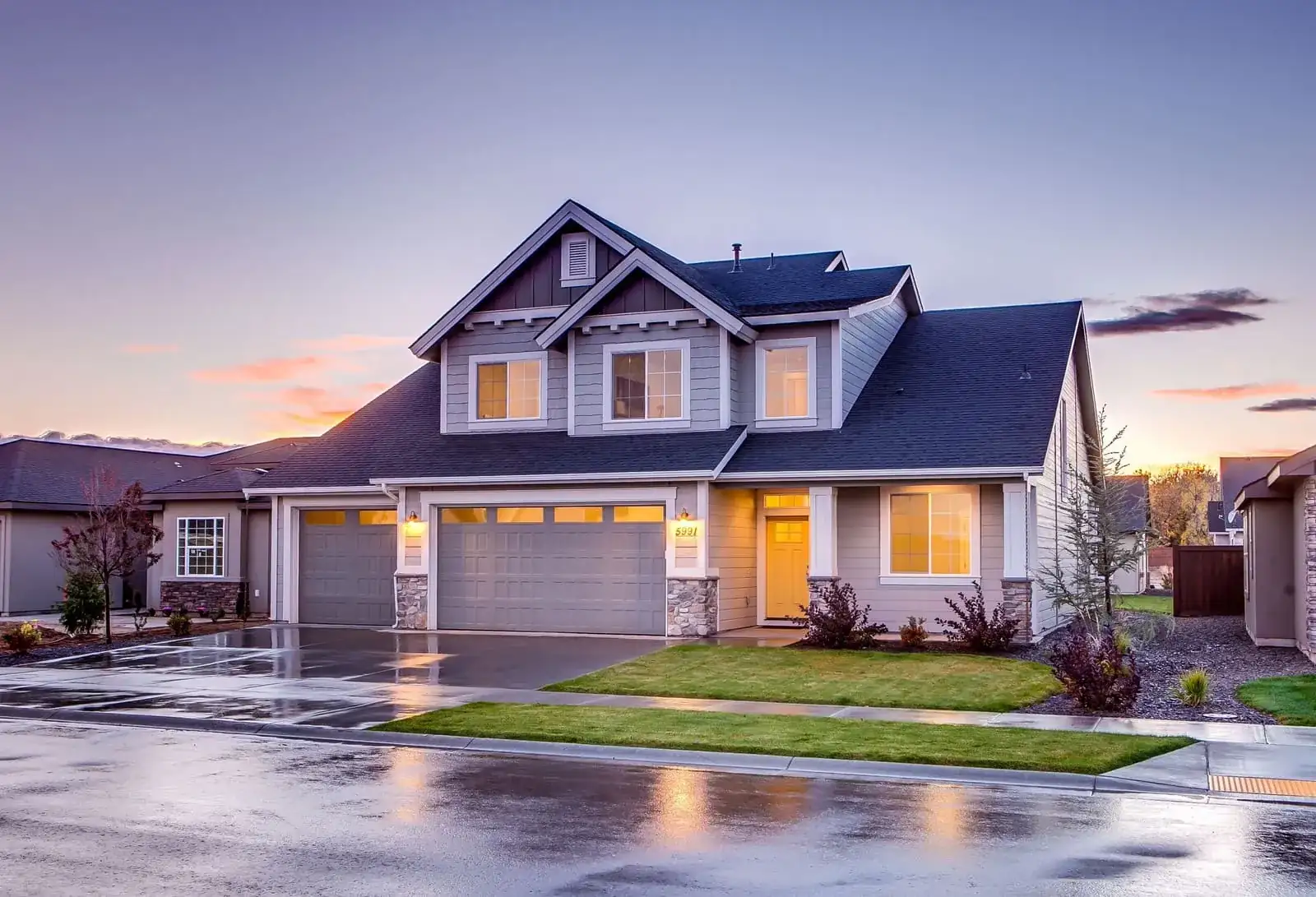 A new insulated garage door on a suburban home at dusk