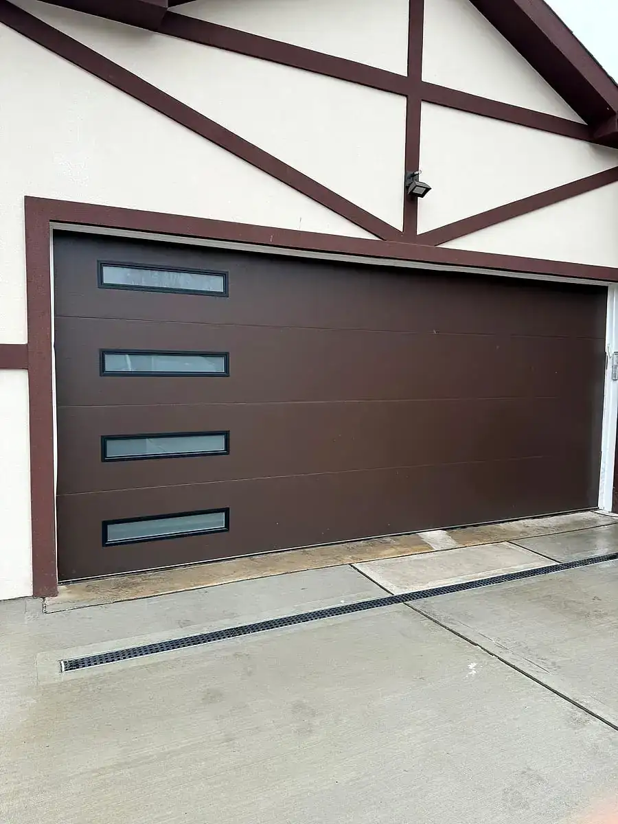 Dark brown modern door with side windows on a Tudor-style home