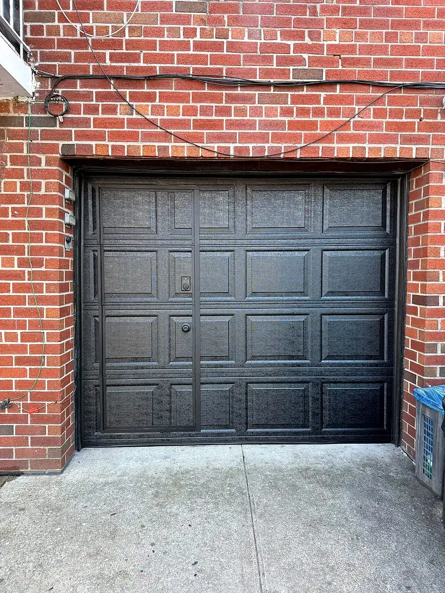 Black short-panel door in a red-brick opening